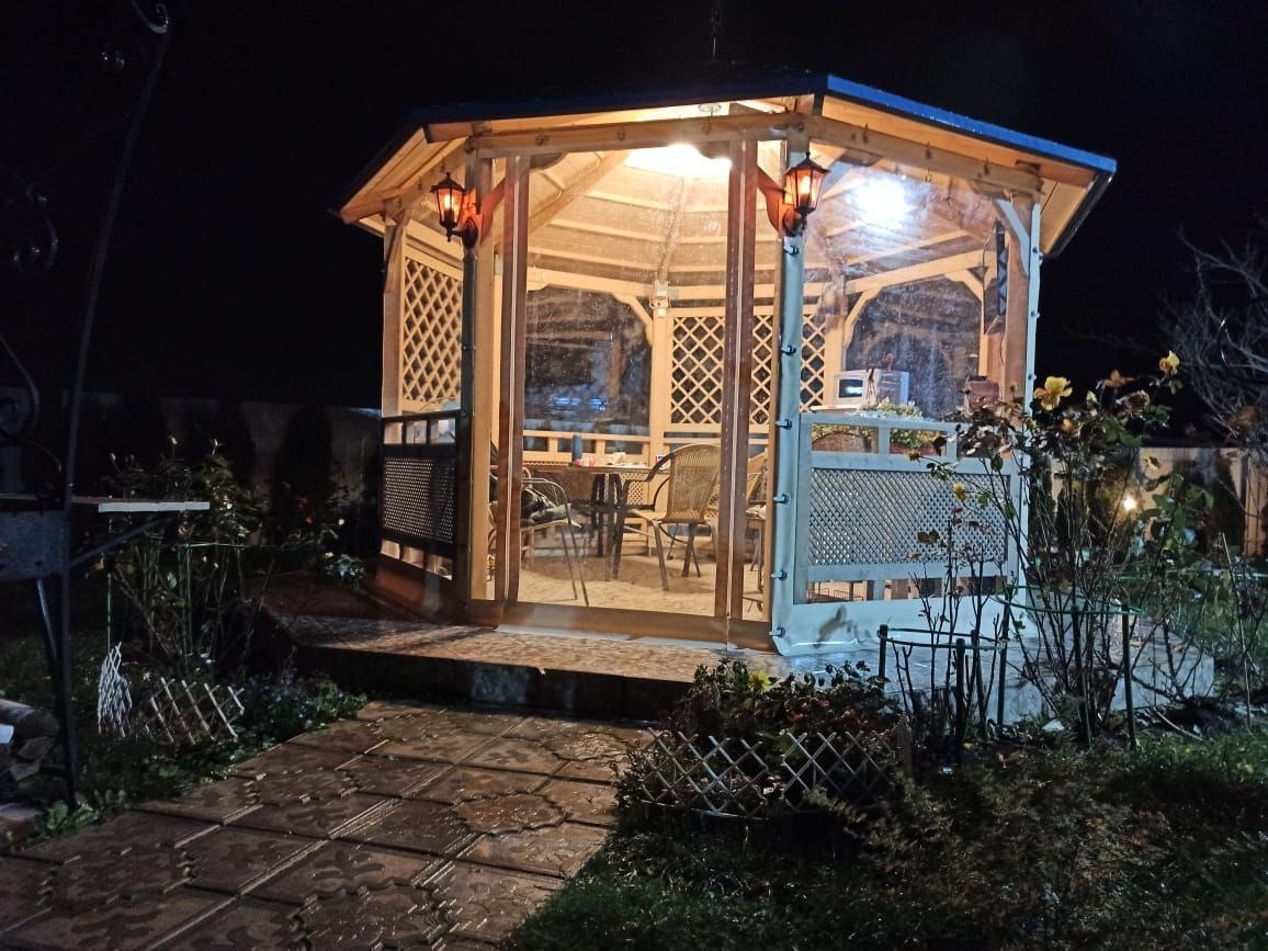 Мягкие окна ПВХ на освещенной садовой беседке в Каменке